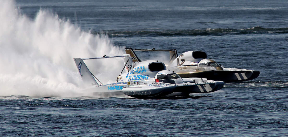 Driver Corey Peabody, left, in the U-9 Miss Beacon Plumbing unlimited hydroplane outruns Andrew Tate in the U-91 Miss Goodman Real Estate to claim the checker flag in the championship race of the 2023 Columbia Cup.