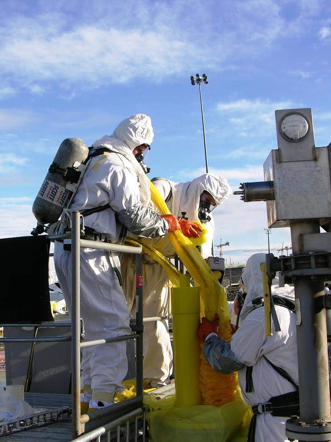 Hanford tank farm employees work to remove a camera while keeping radioactive contamination from spreading at the nuclear reservation’s tank farms.