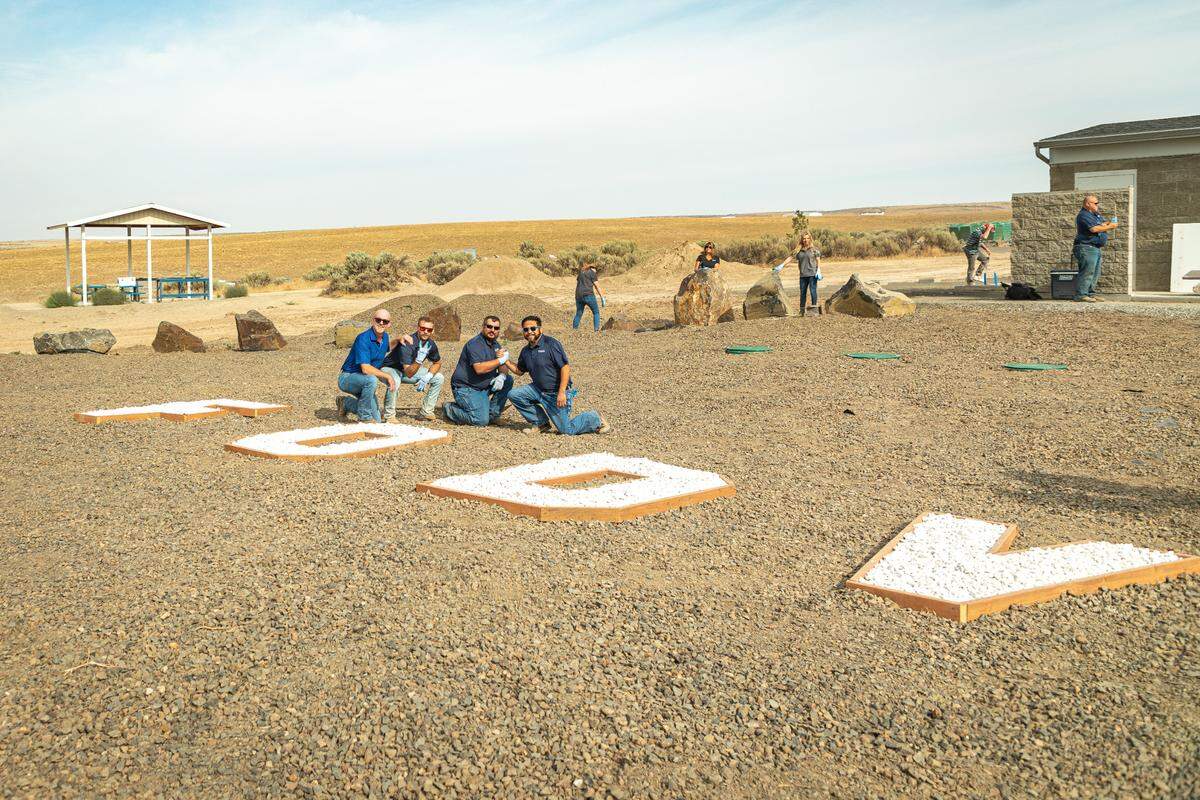 Volunteers with Hayden Homes pose in a new sensory garden at the Ranch, a planned retreat being built by the Friends of Disabled Veterans.