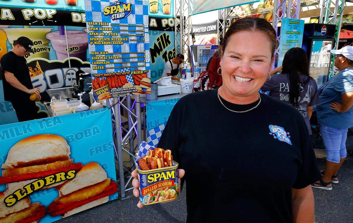 Charity Rocha, owner of Rocky’s Concessions, holds a can of sauce-covered Spam fries they’re serving up this year at the Benton Franklin County Fair & Rodeo in Kennewick.