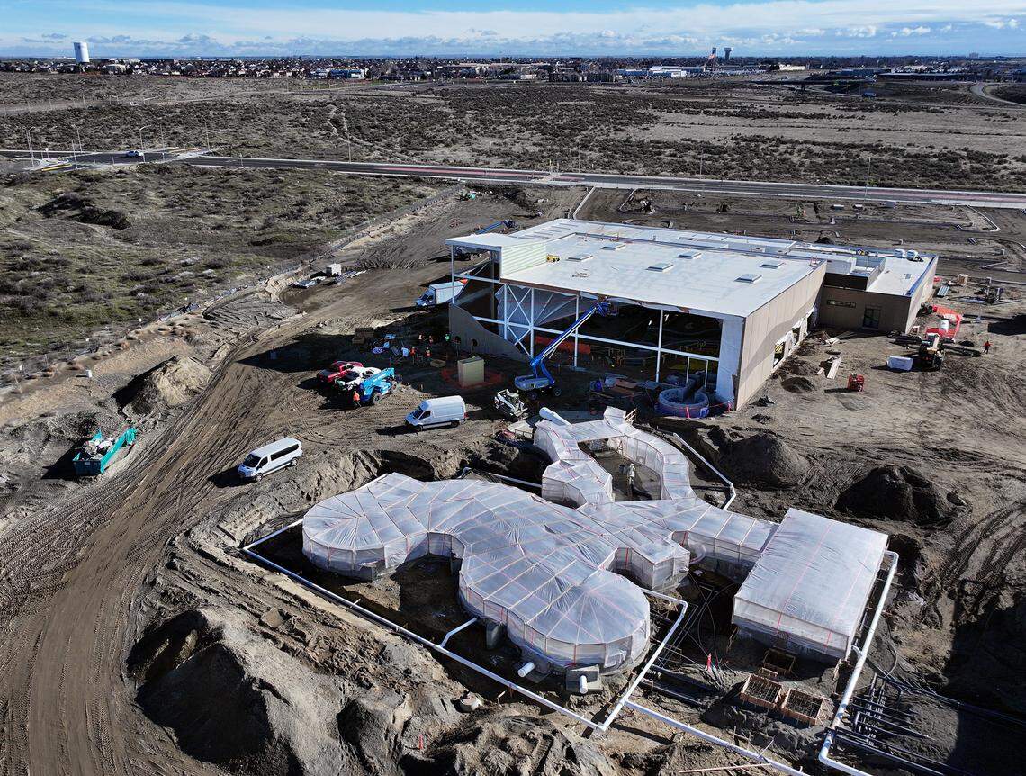 Temporary tarps encase the outdoor lazy river as construction crews work inside the section at the $41 million Pasco Aquatic Center off Road 108 in west Pasco.
