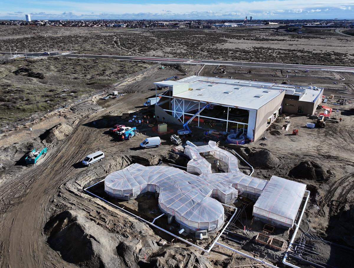 Temporary tarps encase the outdoor lazy river as construction crews work inside the section at the $41 million Pasco Aquatic Center off Road 108 in west Pasco.