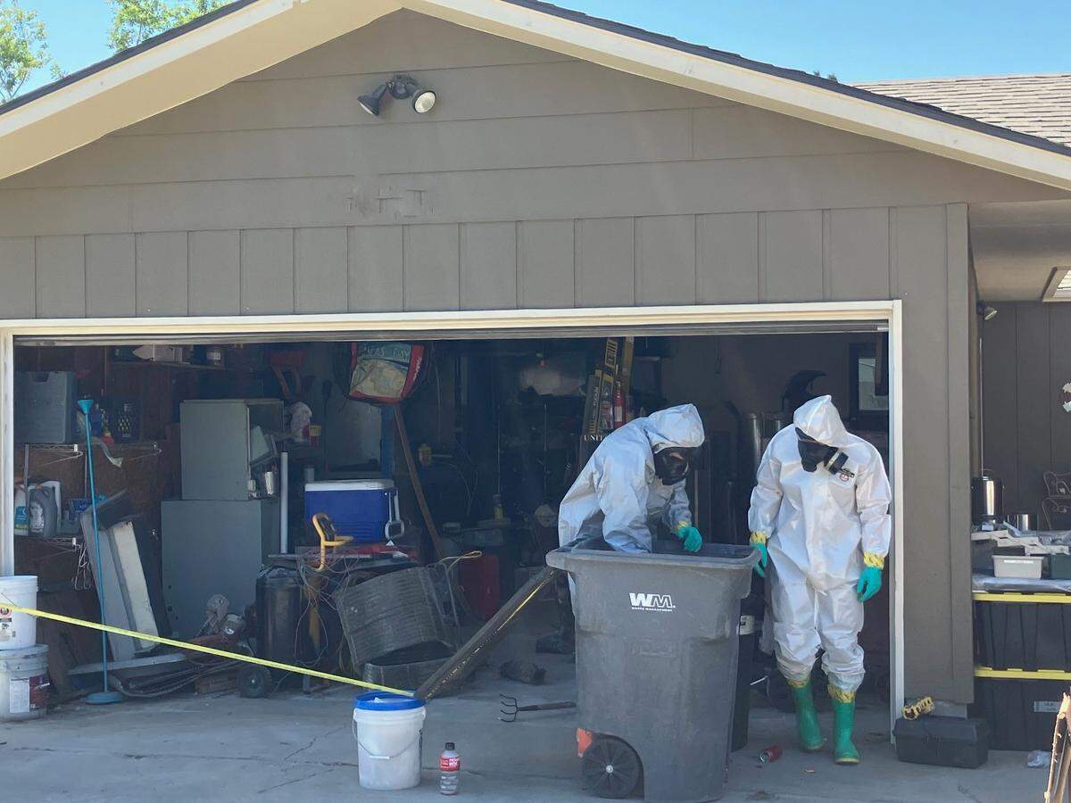 Investigators search through a reported meth lab set up in the garage of a North Quillan Street home in Kennewick.
