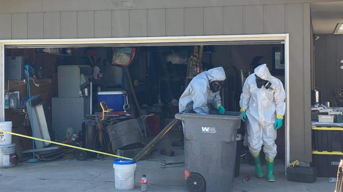 Investigators search through a reported meth lab set up in the garage of a North Quillan Street home in Kennewick.