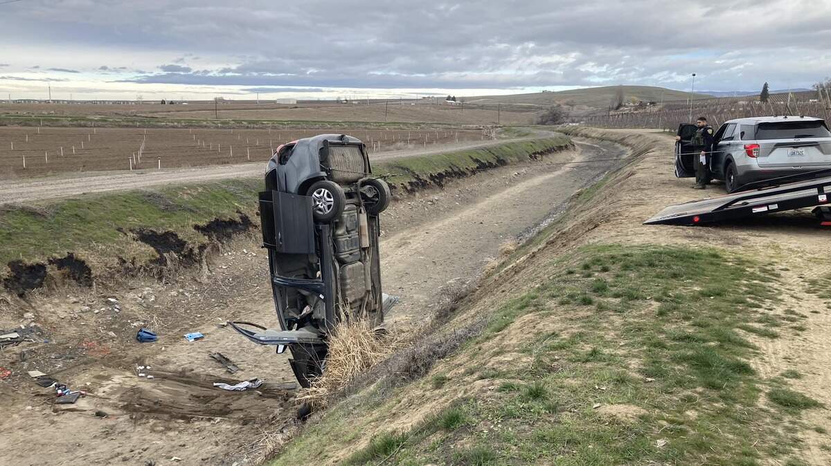 Ken’s Auto Rescue removes a minivan that overturned in a canal near Prosser.