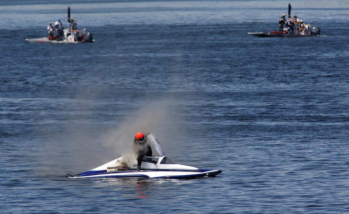 Hydrplane driver Jacob Mauldin climbs out of the cockpit of his burning 2.5 Litre hydroplane race boat after it caught fire in the final turn of the last lap of the rerun of Heat 3 Saturday on the Columbia River. He was able to safely move to a rescue sled that quickly responded.