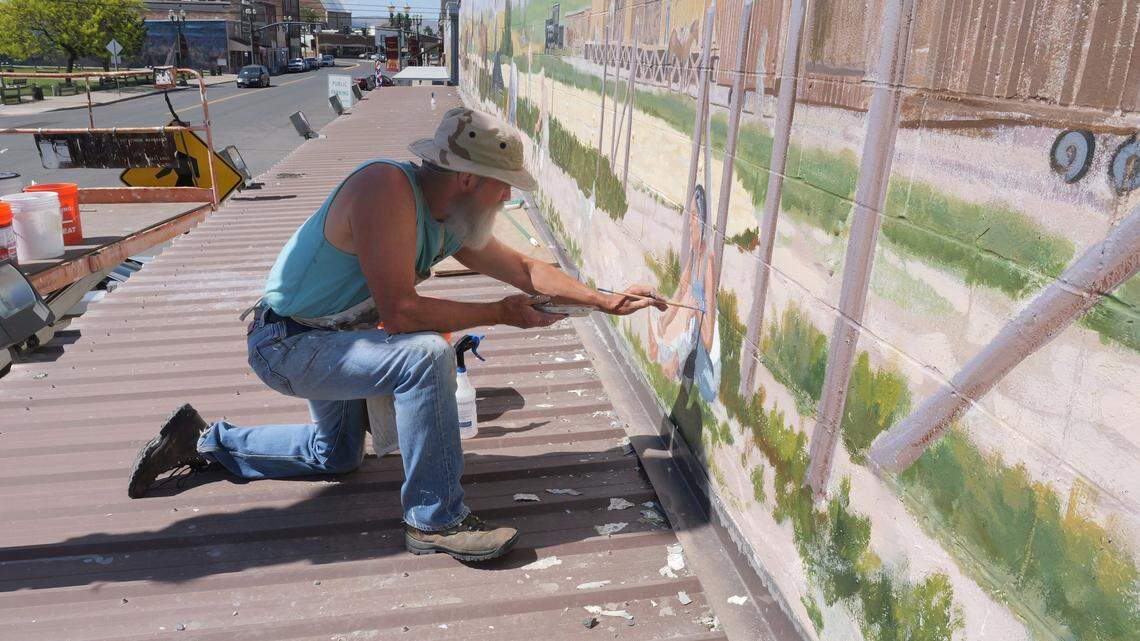 Art restoration work being done by Artist Don Brown on one of the murals called “At the Peak of Harvest” in downtown Toppenish. This mural was originally painted in 1991 by Fred Oldfield with assistance from artists Jack Fordyce, Everett Russell, and Mavis Willson.