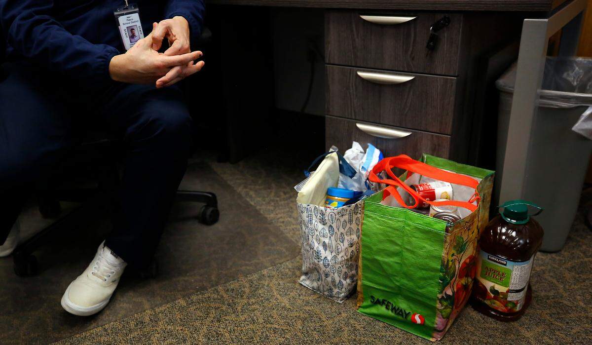 Food donations dropped off for a student sits on the floor of Ivan Barraza’s shared office space, a migrant graduation specialist, at Pasco High School.