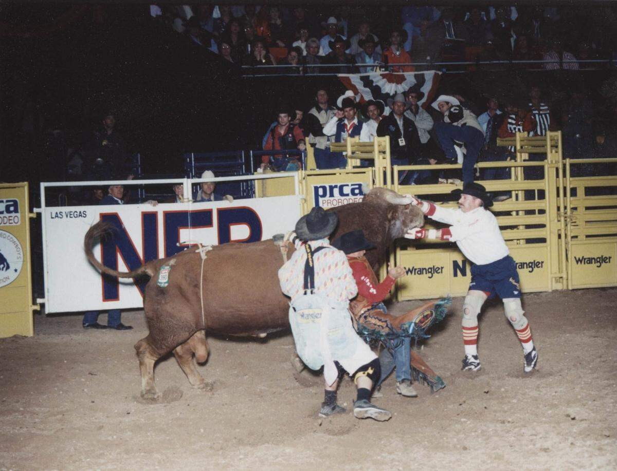 Rowdy Barry, right, helps saves bull rider Josh O’Byrne at the 1999 National Finals Rodeo.