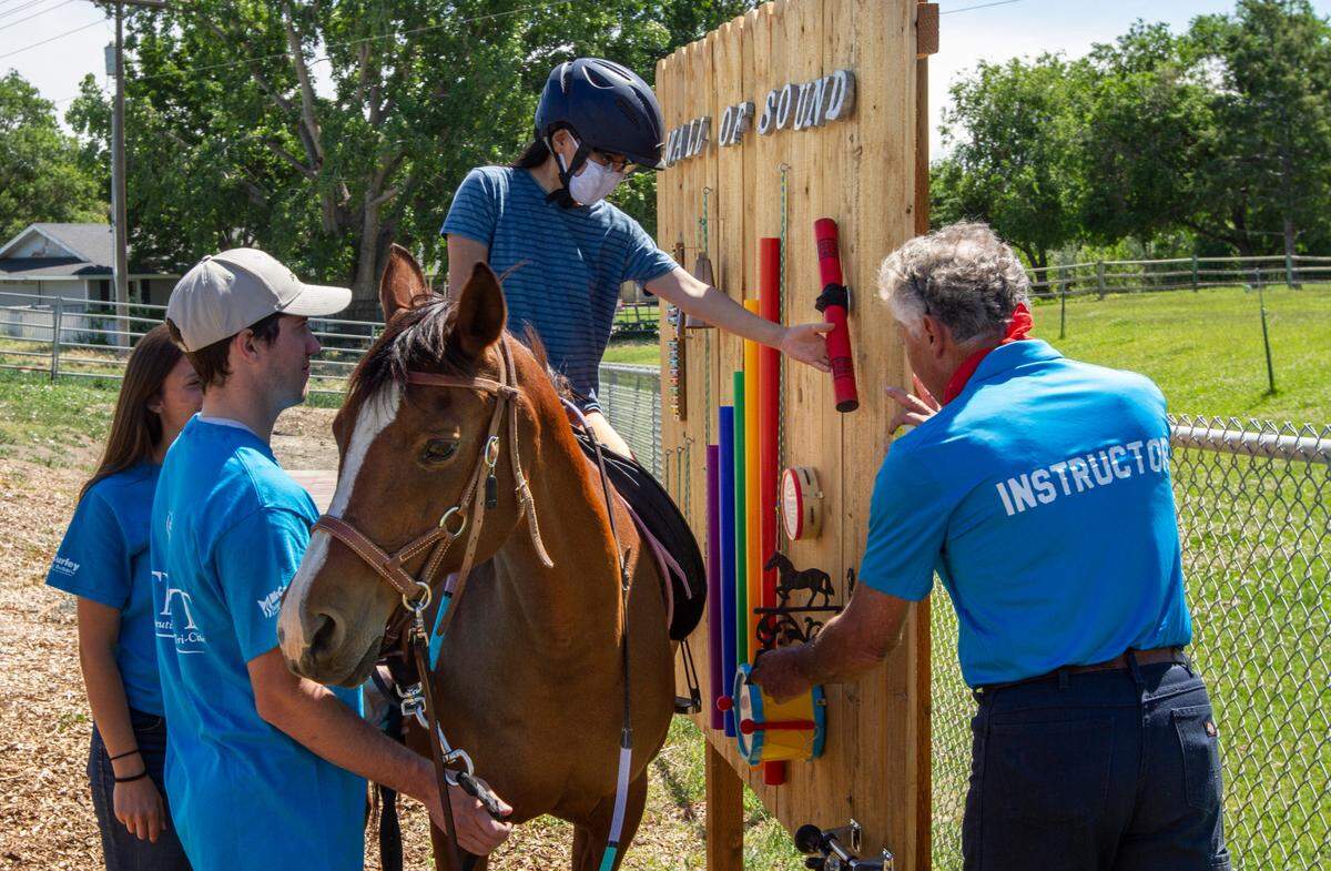 Therapeutic Riding of Tri-Cities (TROT) participants and volunteers try out the new Happy Trails Sensory Course, a five-station custom motor-sensory course created in partnership with the Leadership Tri-Cities Alumni Association. TROT provides specialty programs in the Mid-Columbia, including adaptive horseback riding, for children and adults with mental and physical challenges.