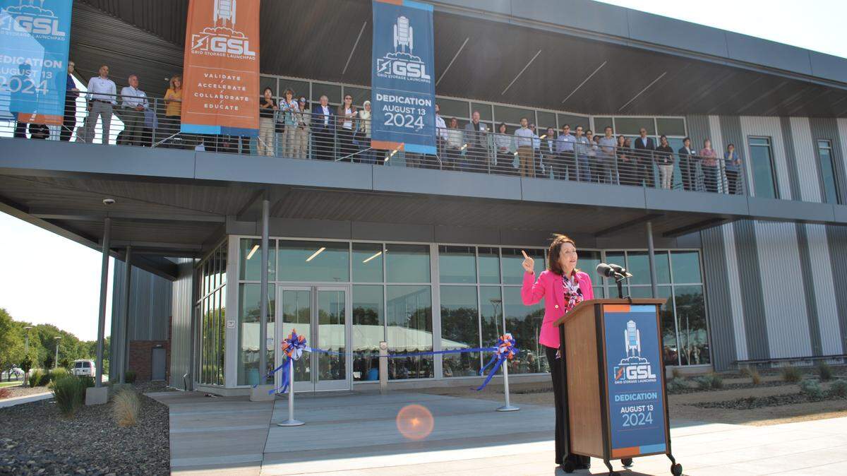 Sen. Maria Cantwell, D-Wash., spoke at the opening of the Grid Storage Launchpad at Pacific Northwest National Laboratory, gesturing to researchers lining its balcony.
