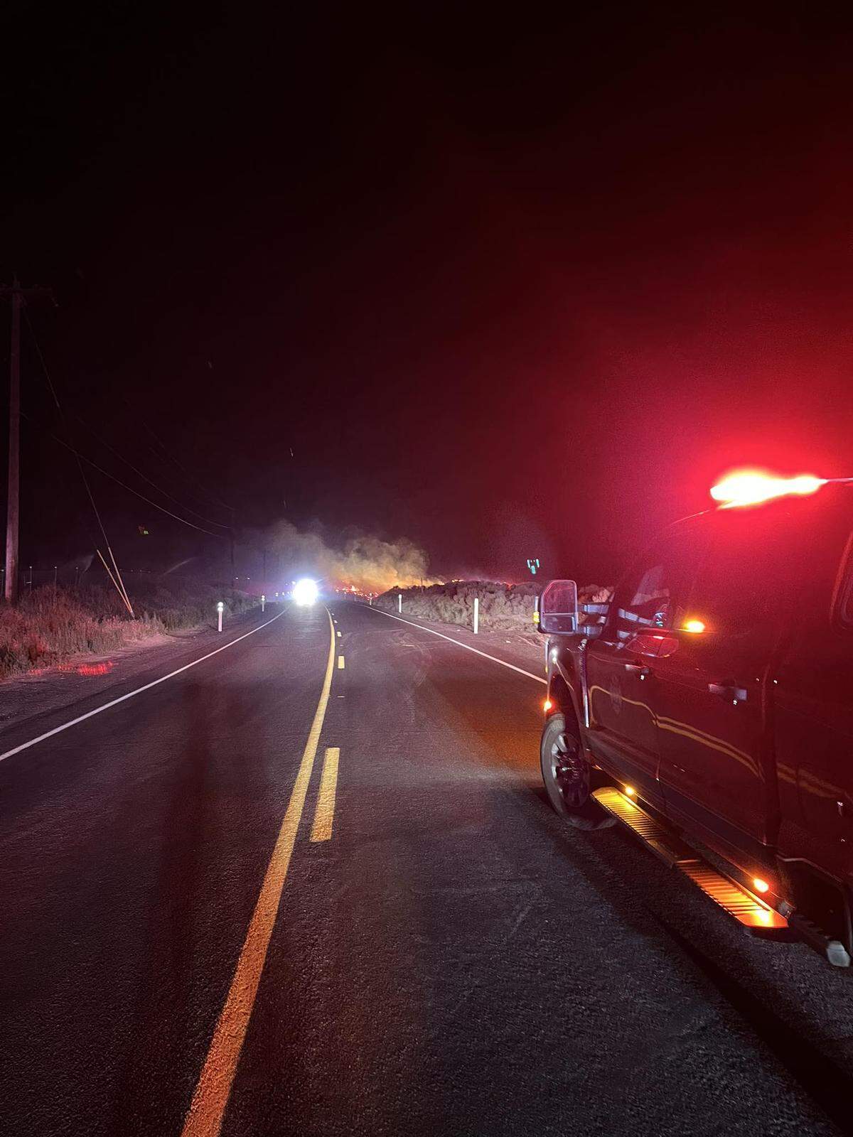 A fire destroyed a home, several vehicles and other buildings after starting in a dry field south of Benton City and West Richland.