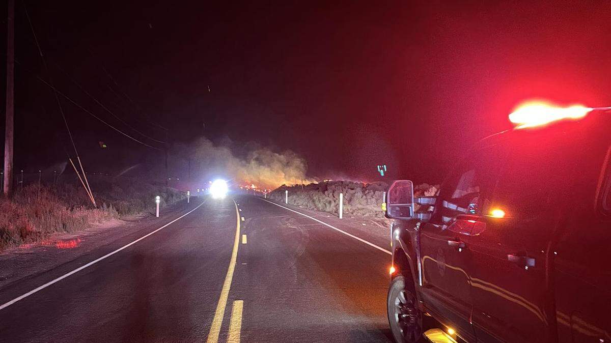 A fire destroyed a home, several vehicles and other buildings after starting in a dry field south of Benton City and West Richland.