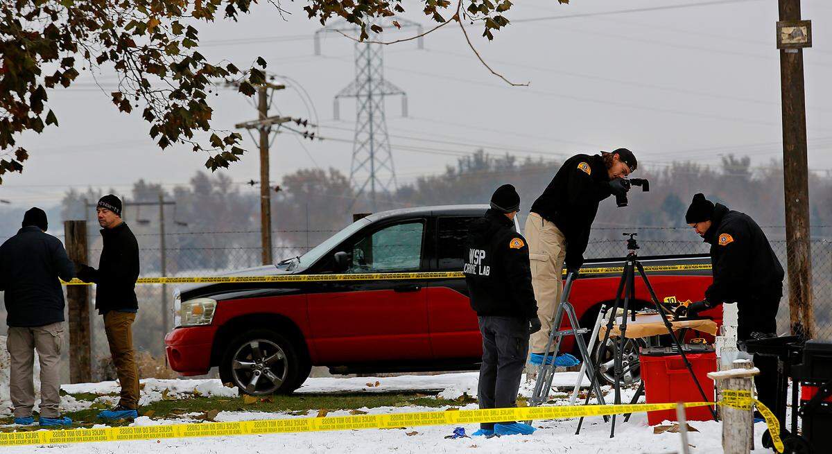 Members of the Washington State Patrol Crime Lab crime scene unit gather and document evidence at the scene of an officer-involved shooting at the Lakeview Manufactured Home Community in east Pasco.