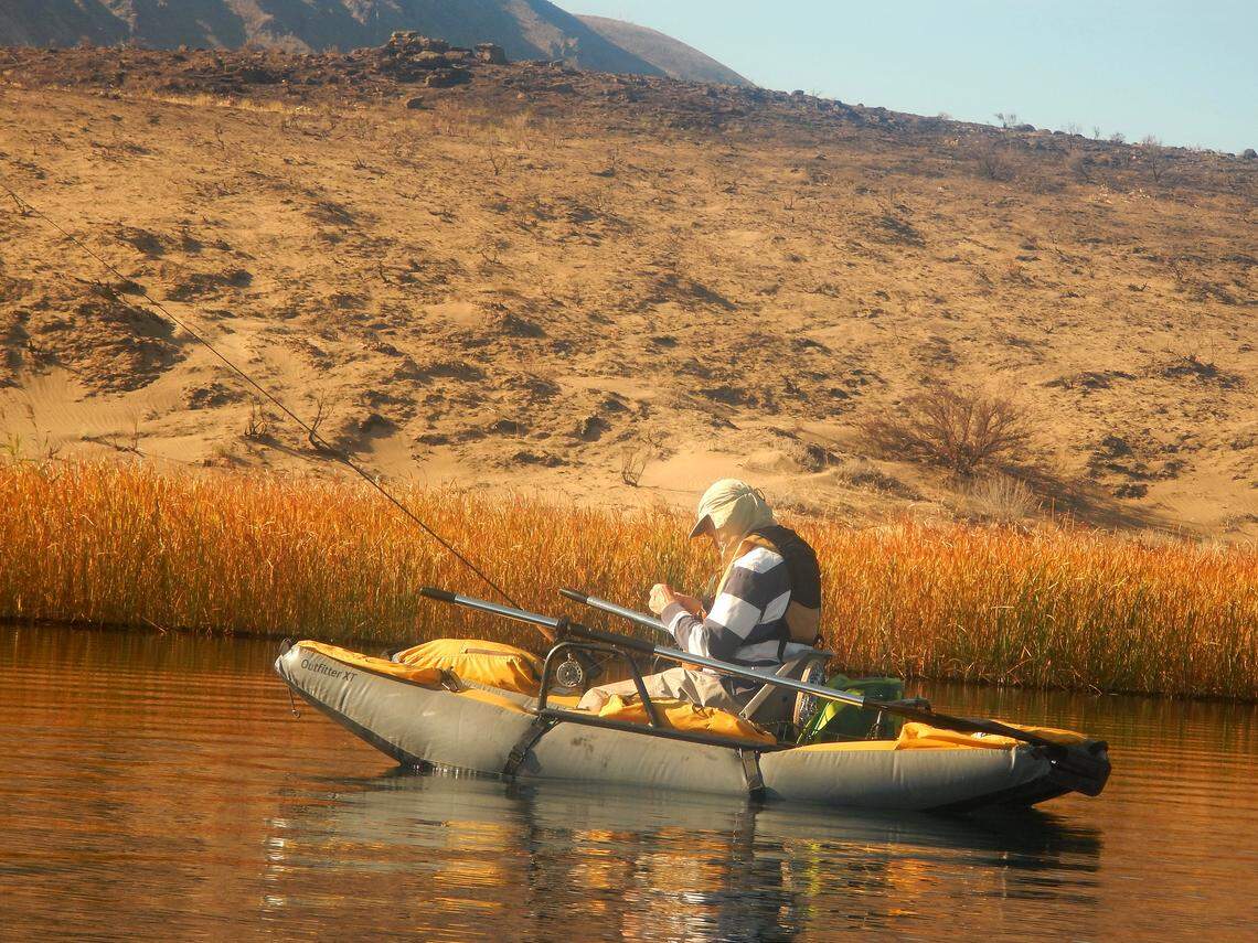 Ted Poston ponders which fly to troll below the placid surface of Lenice Lake.
