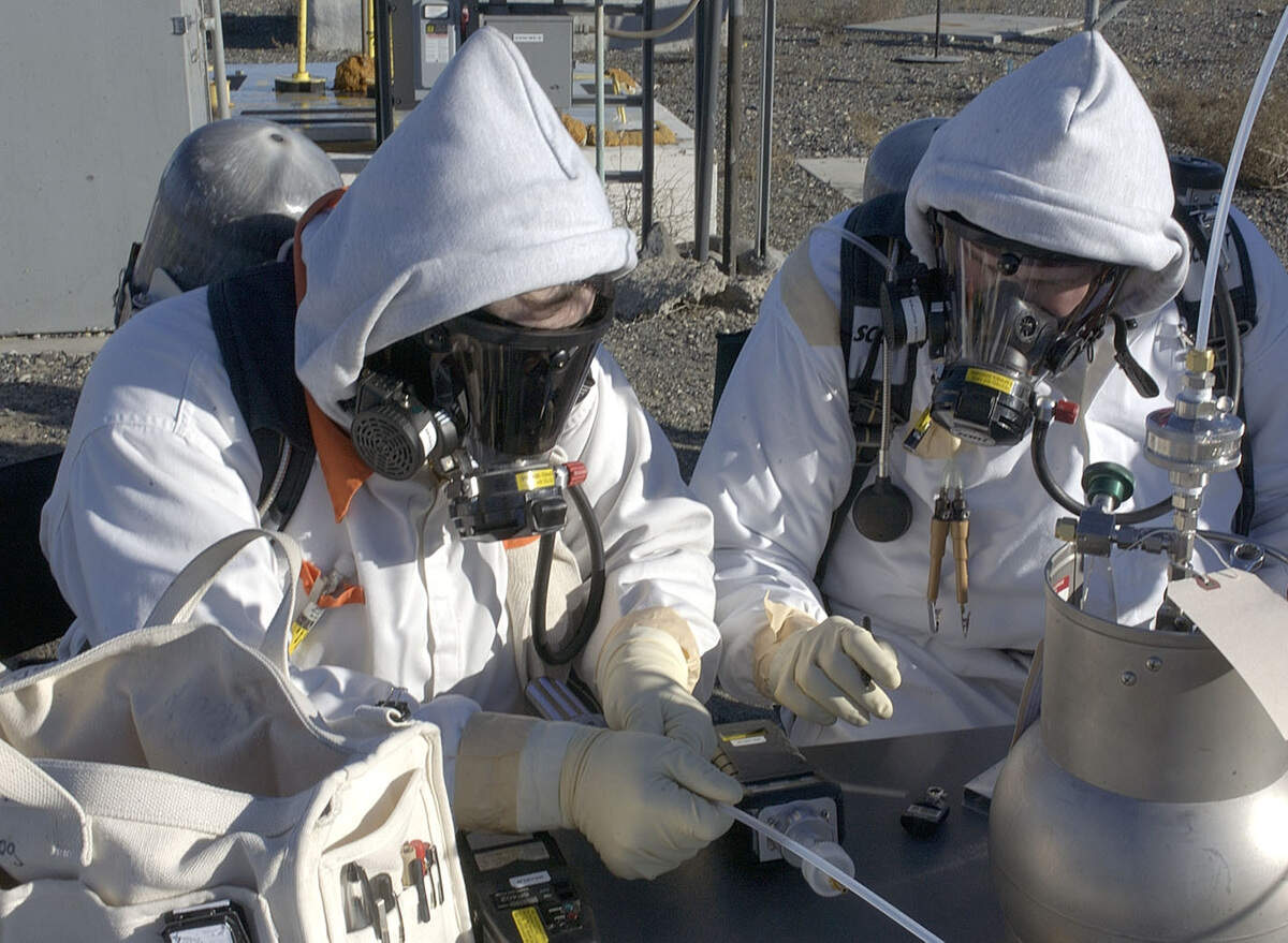 Hanford workers take a sample of the vapors in the head space of one of Hanford’s underground tanks holding high-level radioactive waste.