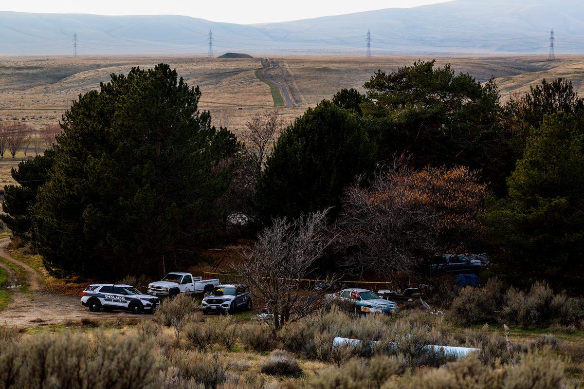 Investigators remained Saturday at a house on North Harrington Road where two bodies were found after a fire. The house is about eight miles west of Richland near the Yakima River and Highway 240.