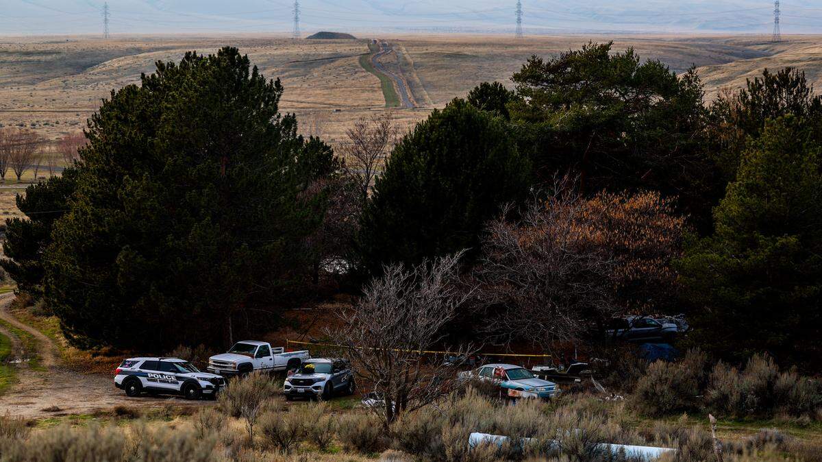Investigators remained Saturday at a house on North Harrington Road where two bodies were found after a fire. The house is about eight miles west of Richland near the Yakima River and Highway 240.