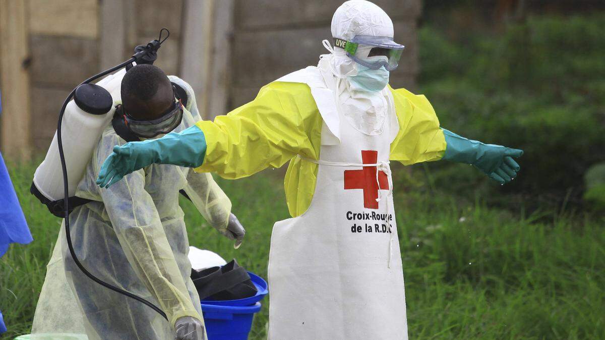 A health worker sprays disinfectant on his colleague after working at an Ebola treatment centre in Beni, Eastern Congo, in September.
