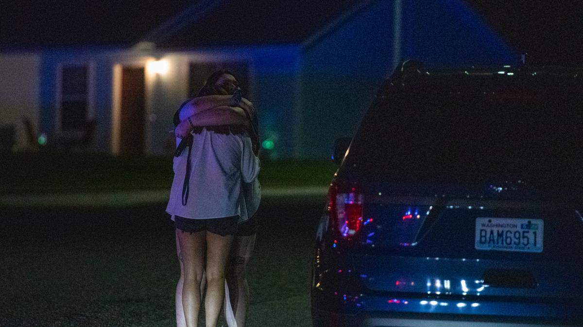 Someone is comforted Saturday night after one person was killed and two others wounded in a shooting at an underage party on the 6000 block of Pimlico Drive.