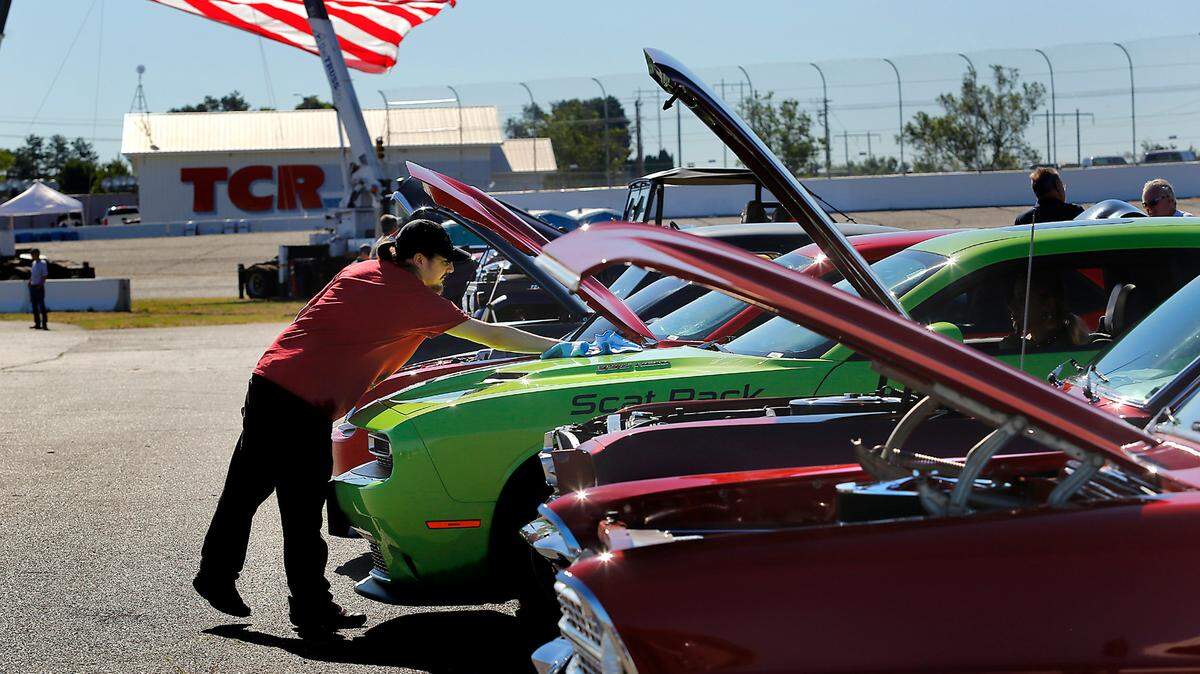 Robert Kisgen of Kennewick cleans his entry into the Cool Desert Night, a 2015 Dodge Challenger, just prior to the opening ceremony of the car show being held at the Red Mountain Event Center in West Richland.