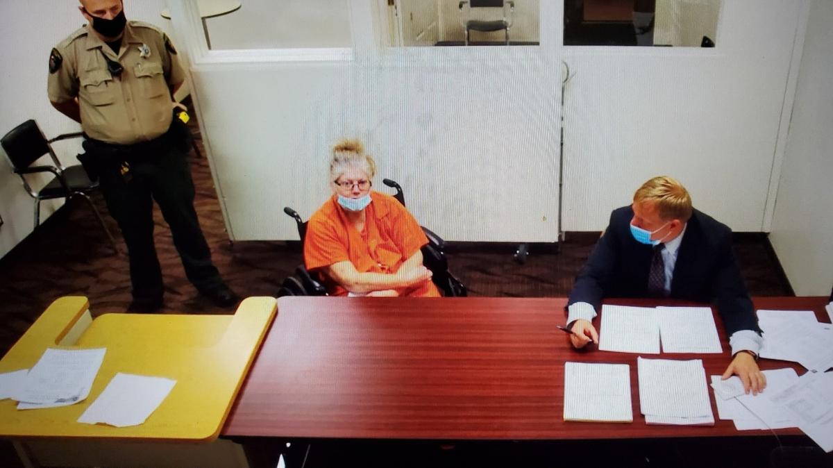 Marta M. Miller, seated in the wheelchair, makes her first appearance Monday in Franklin County Superior Court on a second-degree murder charge. Next to her is defense attorney Eric Scott. They appeared via a video feed from the county jail.