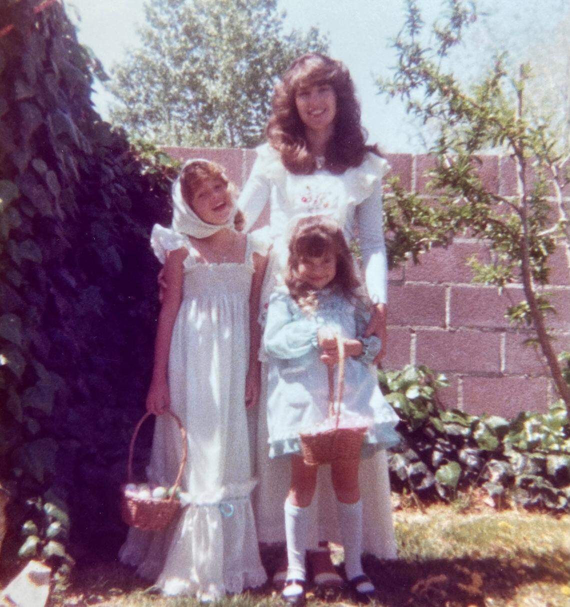 Lucy Luginbill holds daughters Traci and Tiffany close years ago.