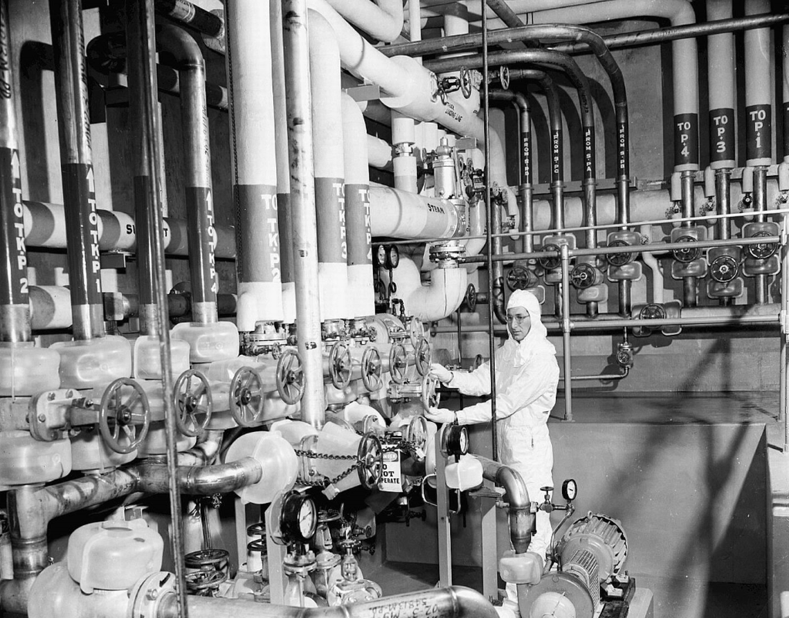 A worker is shown at the Hanford nuclear reservation’s PUREX processing plant in 1956.