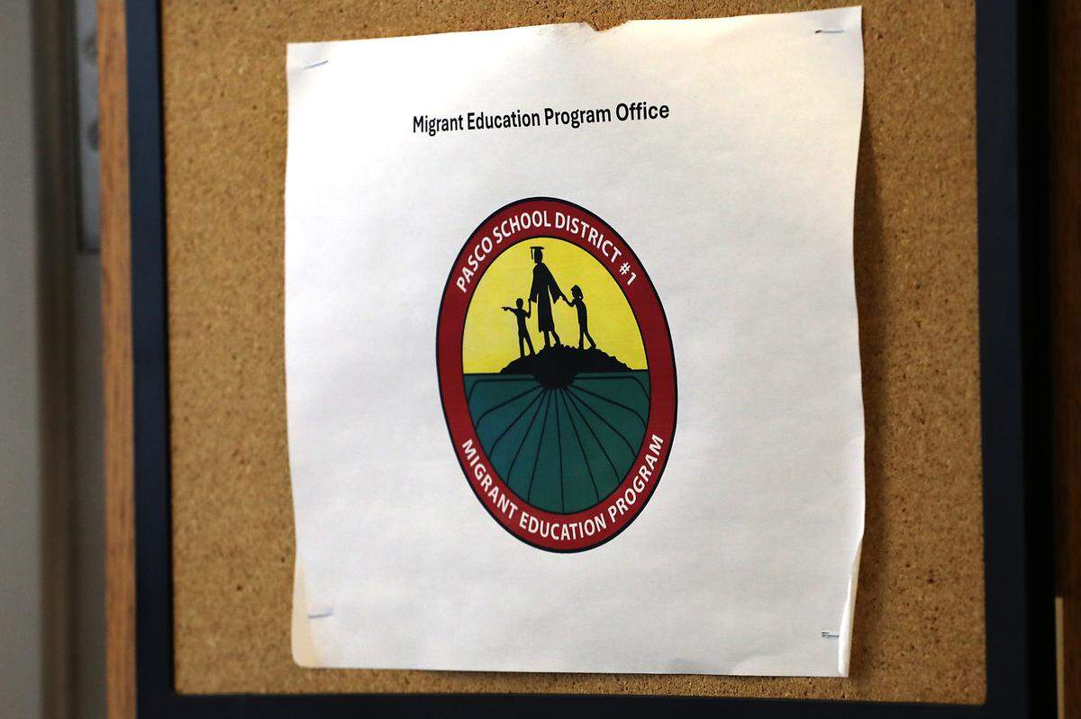 A sign for the Migrant Education Program is posted on the door of the shared office space of Ivan Barraza, a migrant graduation specialist, at Pasco High School.