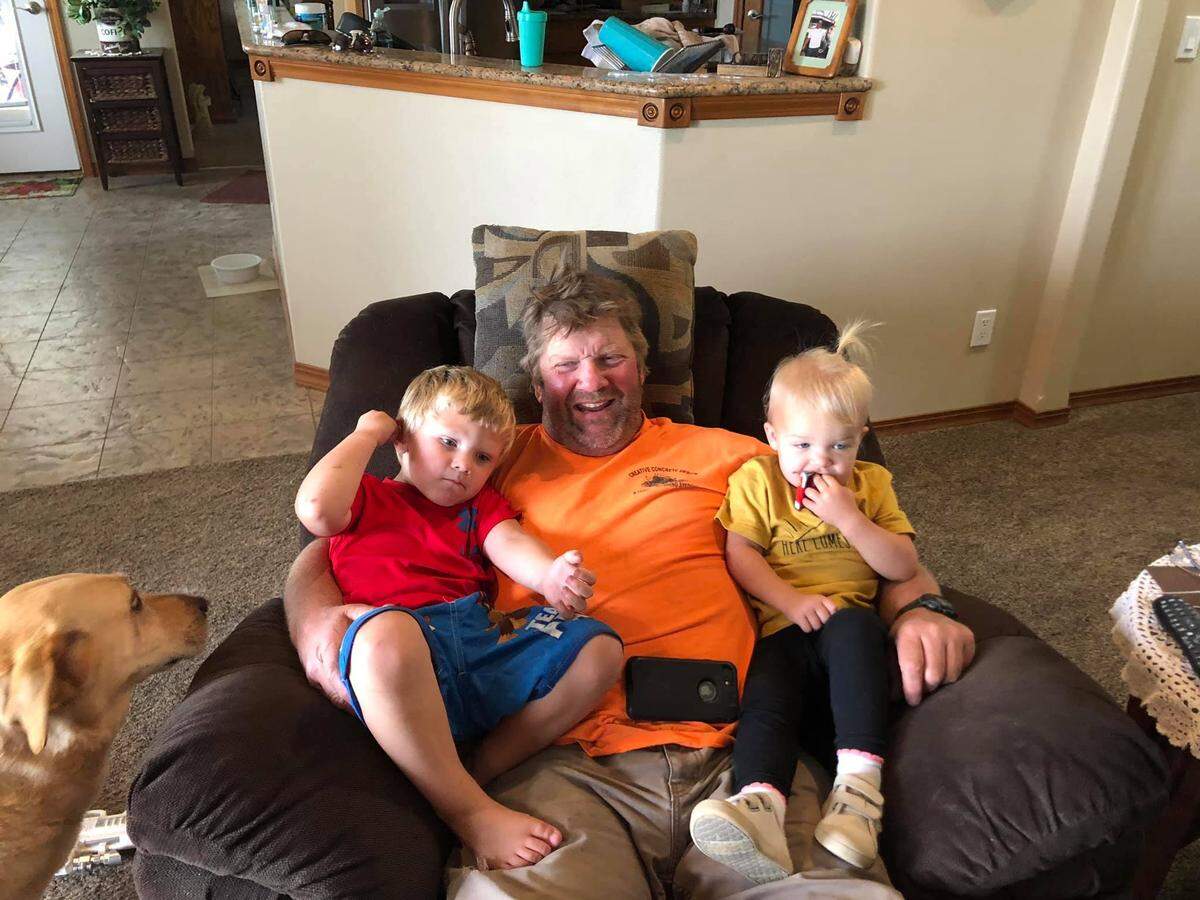 Pasco business owner Mike Welch, seen here with two of his grandchildren, has been fighting COVID-19 since Thanksgiving.