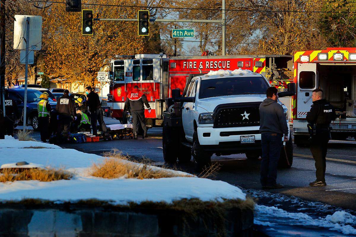 Kennewick Fire Department first responders prepare to transport a critically injured adult female pedestrian to the hospital after she was struck by a pickup truck Tuesday afternoon on the corner of West Fourth Avenue and South Olympia Street in Kennewick
