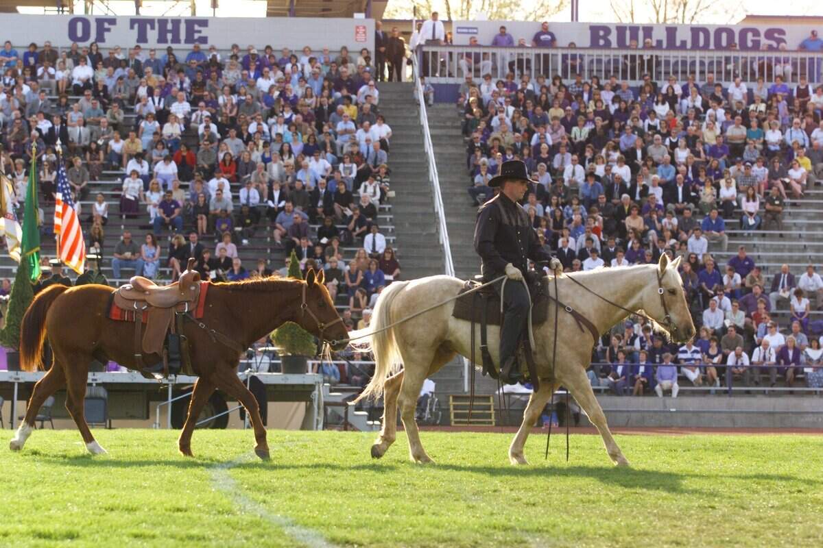 Greg Franklin, a riding partner of Ray Reynolds, leads Reynolds’ favorite horse Rabbit as Danny Boy is sung during a memorial service at Edgar Brown Stadium in 2000.