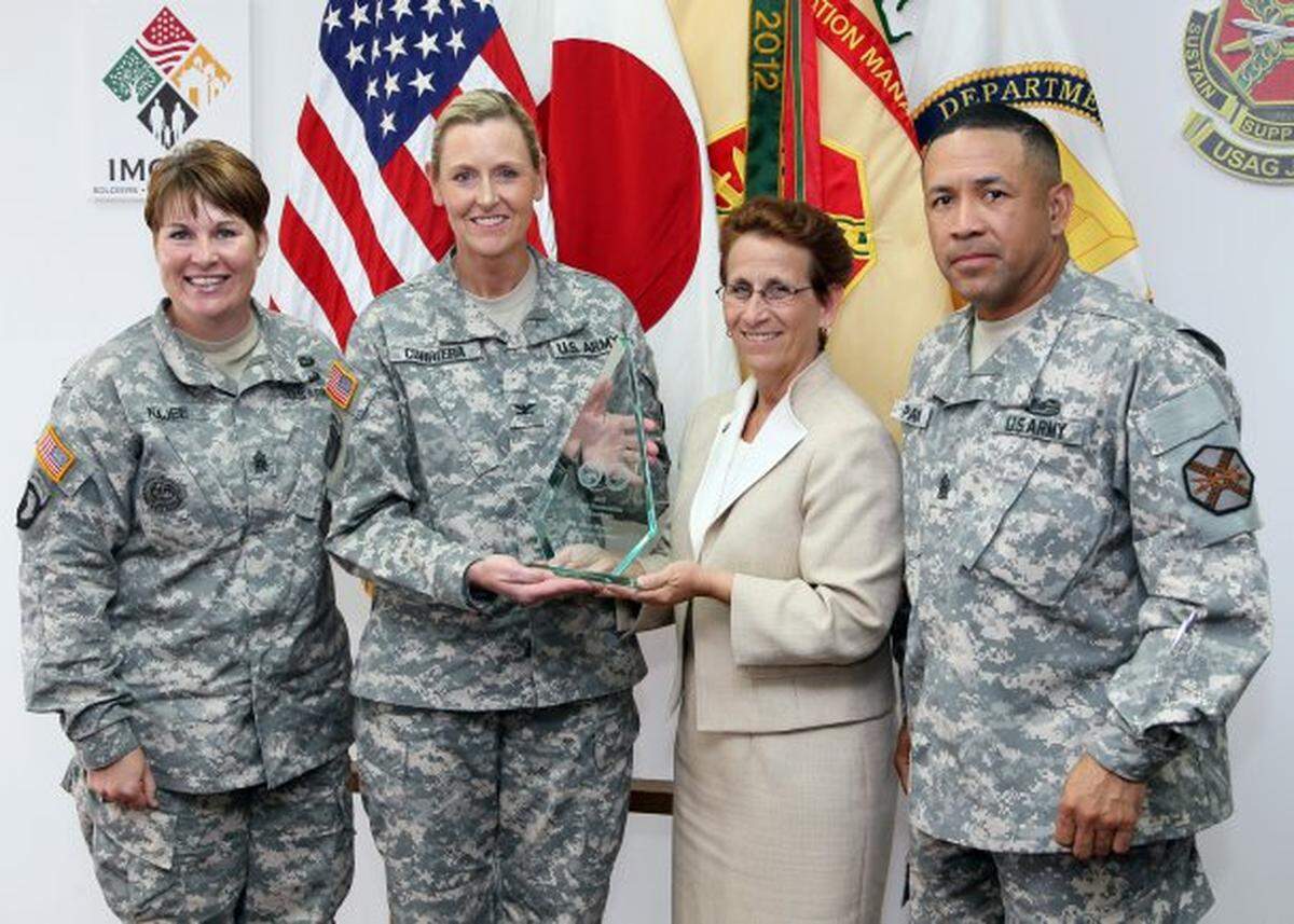 Army Garrison Japan is awarded the silver Army Communities of Excellence award June 24 during a small ceremony. The award was presented to Pasco native Col. Joy L. Curriera (second from left), the acting garrison commander. Also in the photo is Command Sgt. Maj. Katrina M. Najee, garrison command sergeant major; Debra D. Zedalis, IMCOM Pacific regional director; and Command Sgt. Maj. Phillip D. Pandy, IMCOM Pacific Regional command sergeant major;