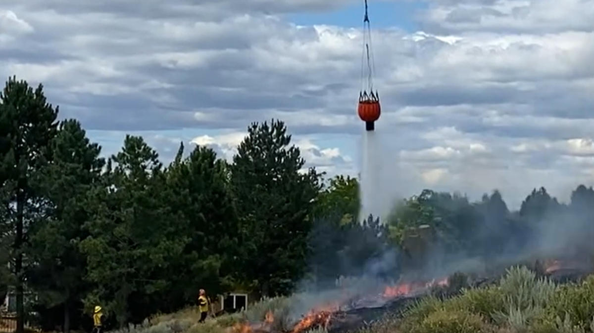 A Department of Natural Resources helicopter dumped water on the Columbia River Road fire Monday.