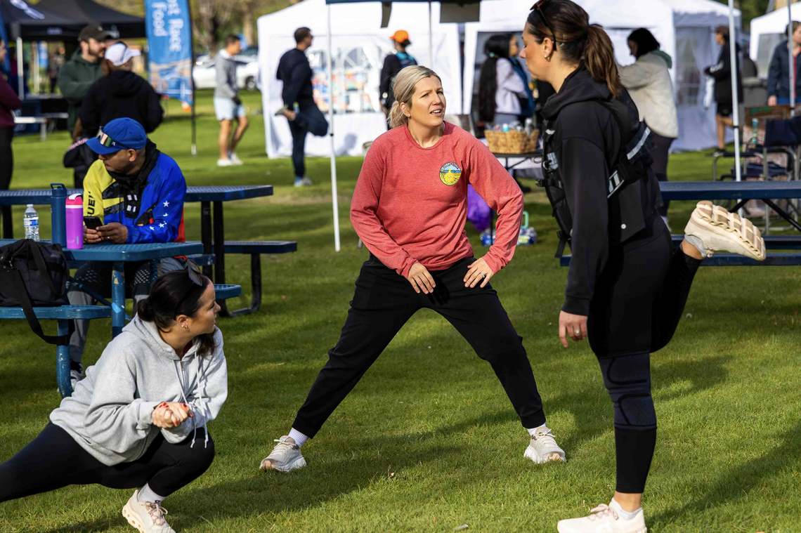 From left, Chelsea Brown, Lindsey Weaver, and Morghan Clark of Walla Walla stretch and warm up before the Run the River race Saturday, April 18, 2026, at Columbia Park in Kennewick. The trio trained together and competed in the half-marathon.