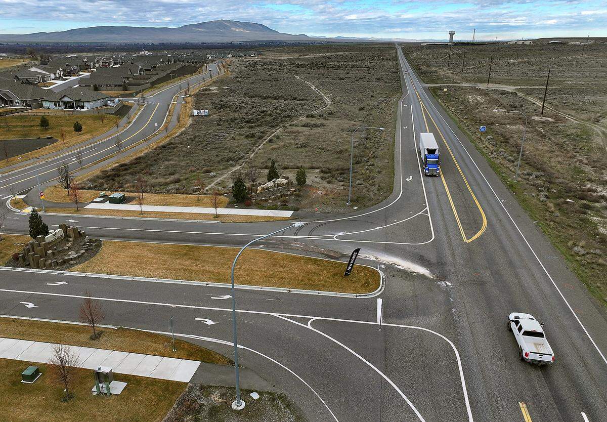 Investigative paint markings, engine fluid stains and debris show the site of the March 1 fatal collision on Highway 240 at Horn Rapids in Richland.