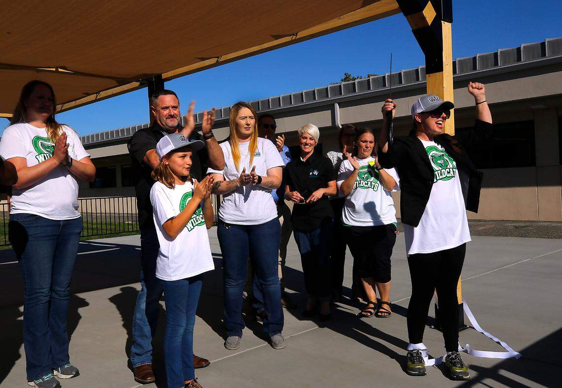 Genie Hernandez, a Mark Twain fifth-grade student, takes part in the ribbon cutting ceremony of her dream that became reality, an outdoor shaded classroom area in the courtyard of the Pasco elementary school on North Road 40. The project was a collaboration between the Mark Twain PTO and donations from community businesses.