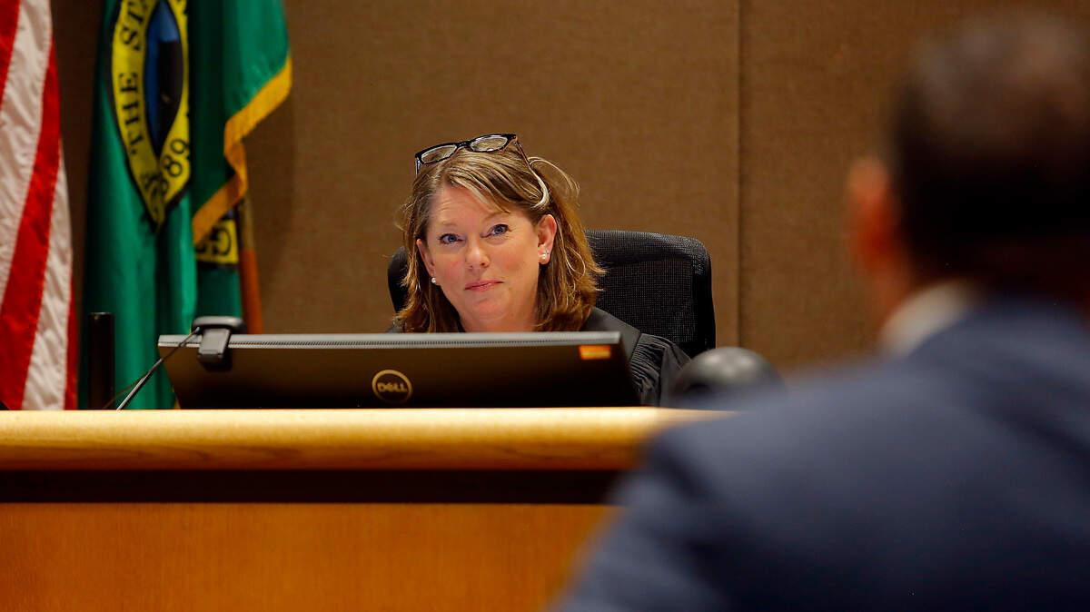 Benton County Court Commissioner Megan Whitmire listens to Charlie Dow, the Benton County manager of the Office of Public Defense, as he explains that murder suspect Michael T. Smith refused to come out of his cell for court.