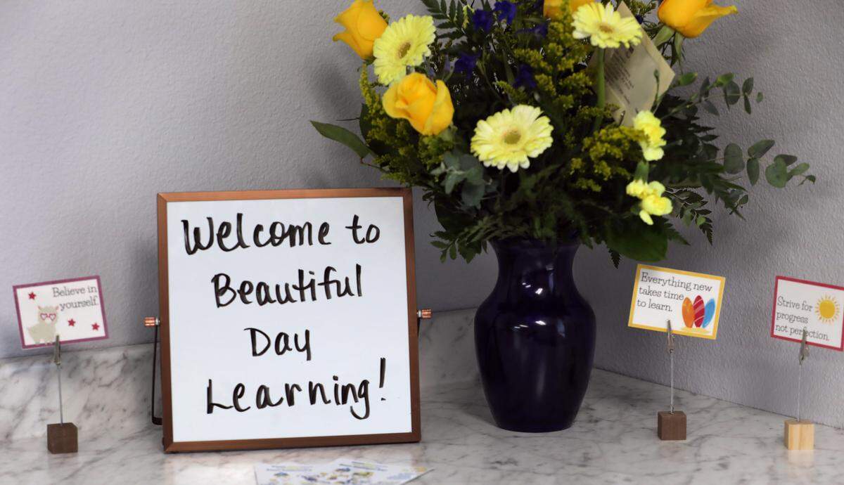 A vase of flowers and inspirational messages are displayed in one of the classrooms at Beautiful Day Learning center in Kennewick shows elements of classroom work. The new facility is designed to provide ongoing education for adults with intellectual disabilities.