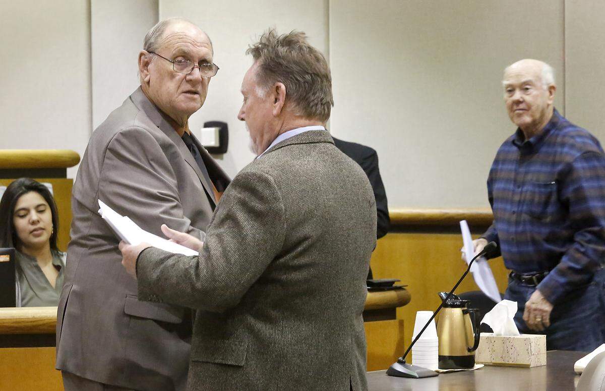 Kennewick resident Richard Bilskis, left, and attorney Bob Thompson talk after a hearing in Benton County Superior Court earlier this month about the recall petition filed against Kennewick Mayor Don Britain. Bilskis filed the petition and Jerry Martin, far right, supports the effort. Thompson is representing Britain.