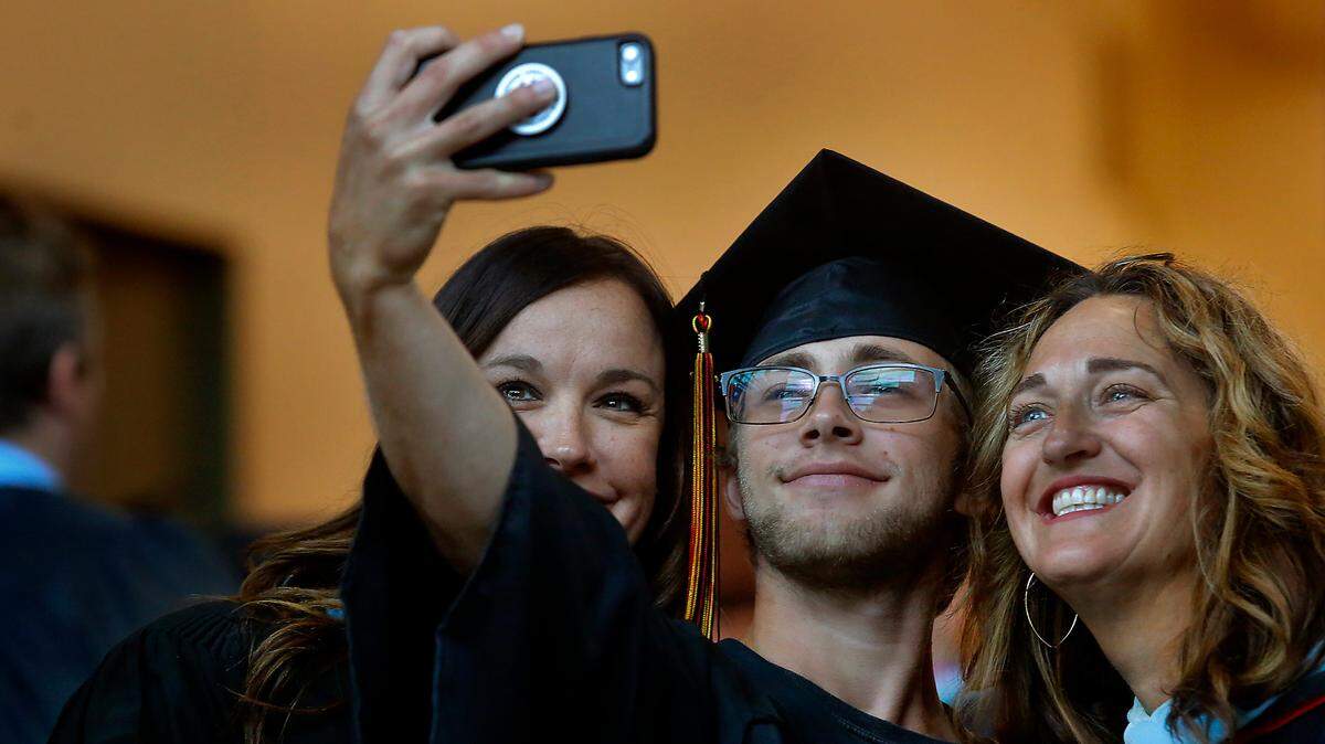 River’s Edge graduate Ash Broyles takes a selfie with counselor Chandra Markel, left, and principal Nicole Anderson on Friday morning just before the start of the processional for the school’s commencement ceremony. Several hundred family members and friends of the school’s 50 graduates attended the ceremony at the Three Rivers Convention Center in Kennewick.