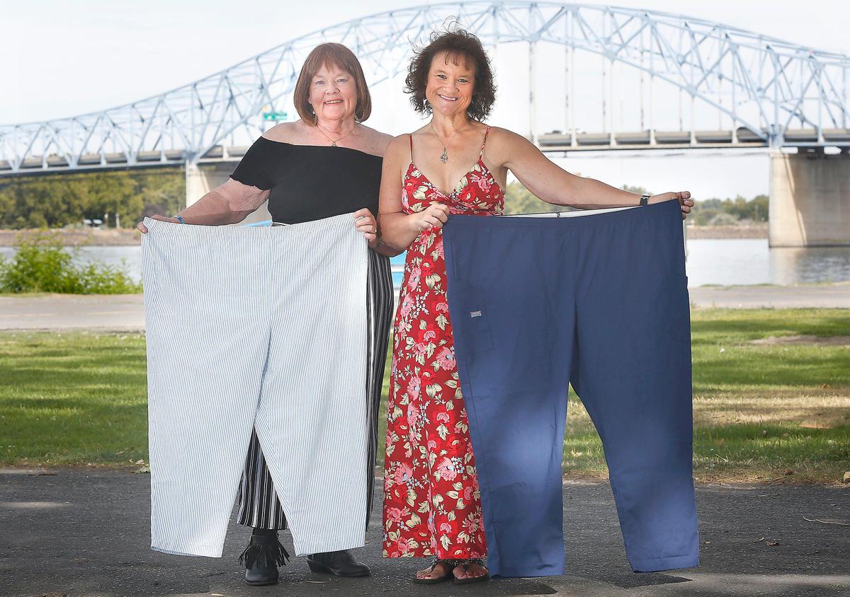 Carol Nicholson, left, and her daughter, Nicol Ramsey, each hold a pair of pants they used to wear before losing a combined total of 305 pounds in two years through the Take Off Pounds Sensibly (TOPS) non-profit program. Nicholson lost 101.5 pounds and Ramsey lost 203.5 pounds. Watch a video at: tricityherald.com/video