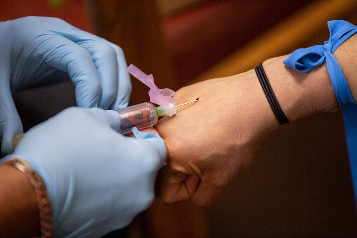 Registered nurse Steve Daulton, 58, draws a vial of blood from Desirae Lyall, 30, of Grandview for a COVID-19 antibody test at Encore Wellness 4 Life in Kennewick.