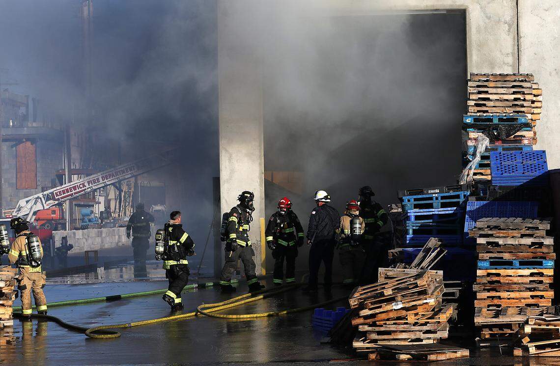 Firefighters from multiple area agencies work to extinguish an early morning 3-alarm warehouse fire on East Ainsworth Avenue in the Port of Pasco's Big Pasco Industrial Center.