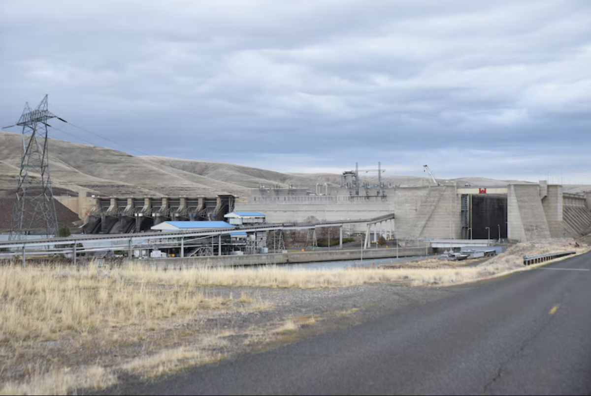 The small drawbridge is shown in its down position at the right side of the dam near the entrance to the lock below the red Corps logo.