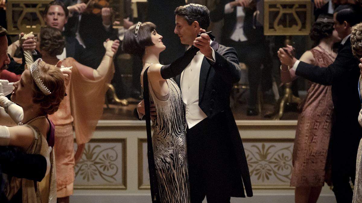 This image released by Focus features shows Michelle Dockery as Lady Mary Talbot, center left, and Matthew Goode as Henry Talbot in a scene from “Downton Abbey.” The highly-anticipated film continuation of the “Masterpiece” series that wowed audiences for six seasons, will be released Sept. 13, 2019, in the United Kingdom and on Sept. 20 in the United States.