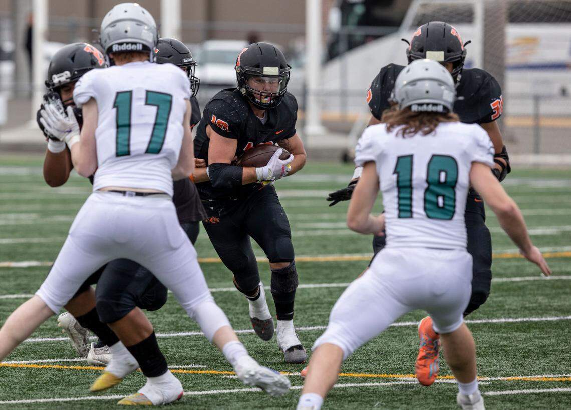 Kennewick Lions senior Myles Mayovsky looks for a pocket during the 3rd quarter of the playoff game against the visiting Spanaway Lake Sentinels at Lampson Stadium in Kennewick.