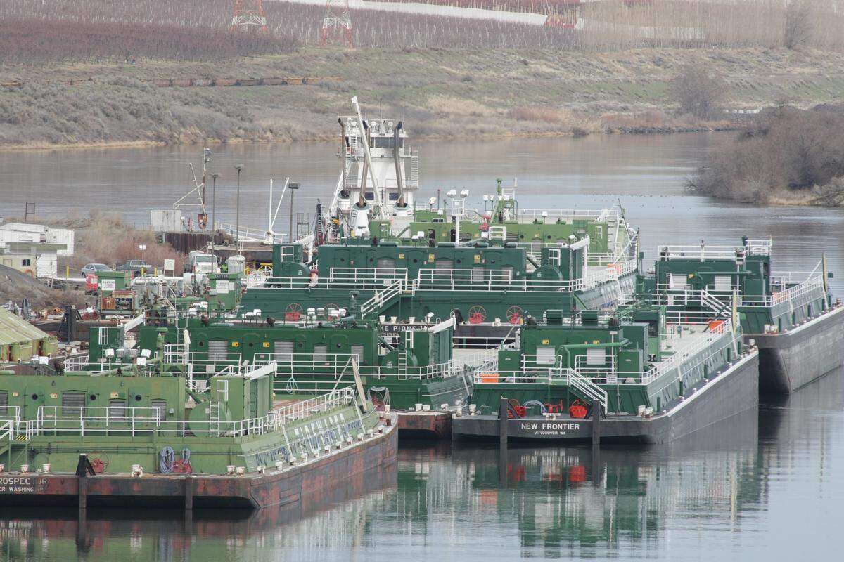 Empty barges and a tugboat sat idle on the Snake River near Pasco as the navigation locks on the Snake and Columbia rivers were shut down for maintenance.