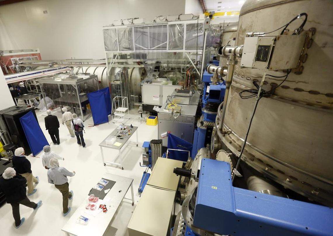 A tour group walks past a tall chamber Tuesday at the LIGO Hanford Observatory in Richland.