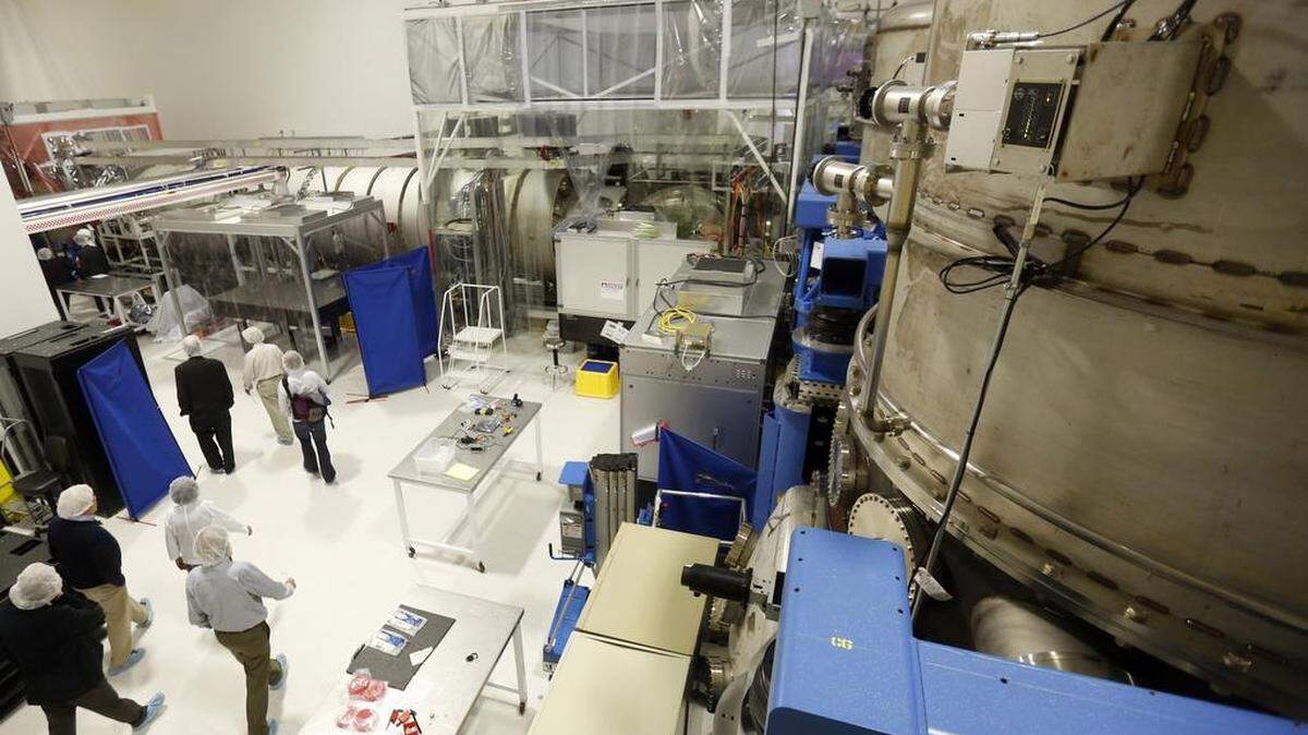 A tour group walks past a tall chamber Tuesday at the LIGO Hanford Observatory in Richland.
